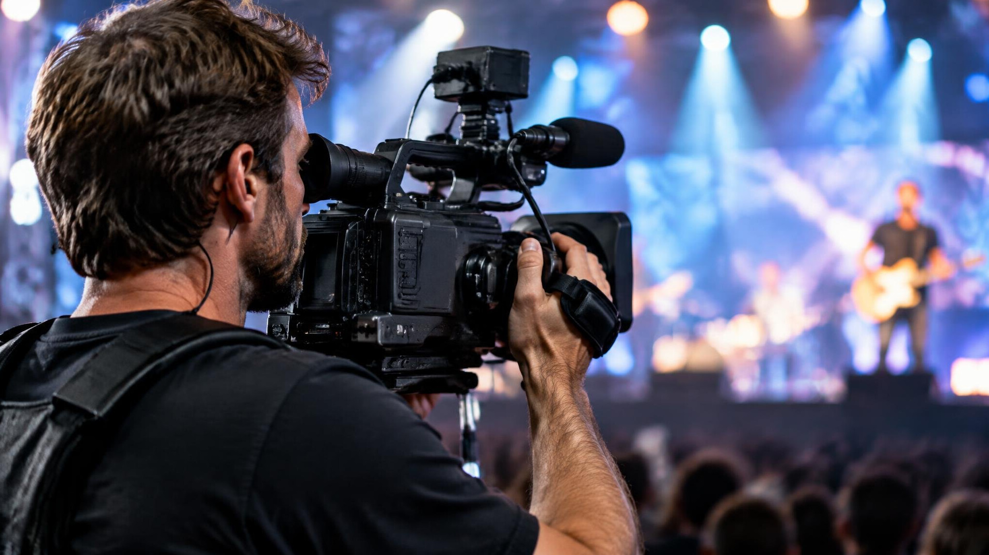 Camera operator filming an event with a professional video camera